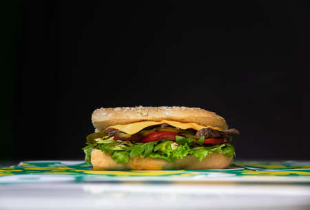 sandwich in a crispy bun with ham and salad.