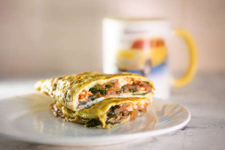 stuffed omelet on a white plate. healthy food breakfast.