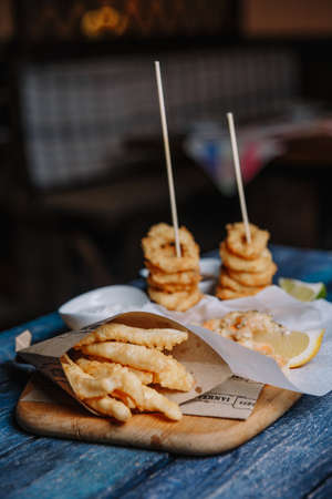 Beer mug and pretzel on wooden table. Top view with copy space.