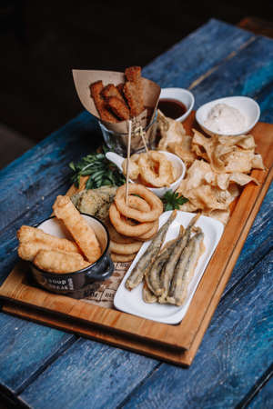 snacks to beer on a blue wooden background.の写真素材
