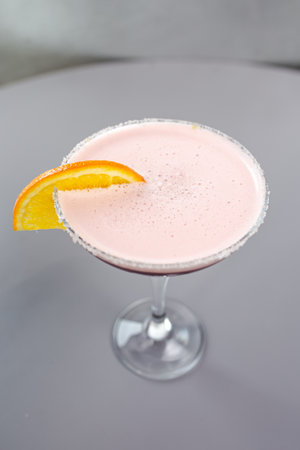 red cocktail with orange on a gray background.の写真素材