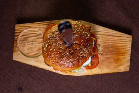 burger on the board with a knife view from above.の写真素材