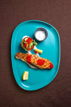 Salmon steak view from above. dish on a birch plate