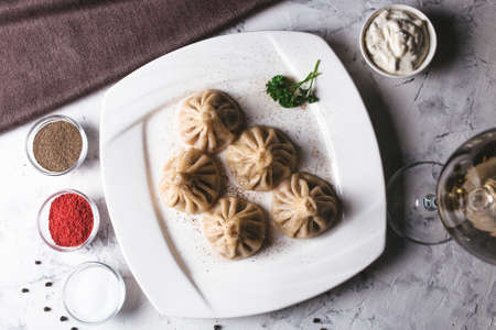 top view Georgian Hinkali on a white plate with sauce in the restaurant.の写真素材