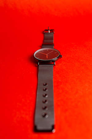 metal wristwatch lie down on a red background.の写真素材