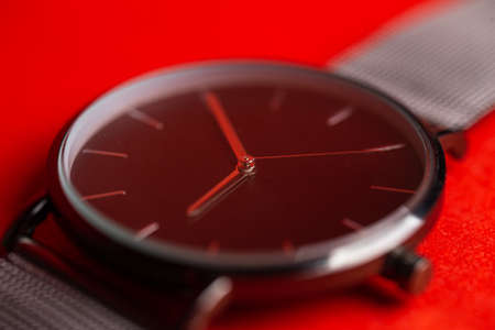 men's wristwatch close-up on a red backgroundの写真素材