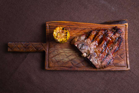 close up juicy beef steak with corn view from top.