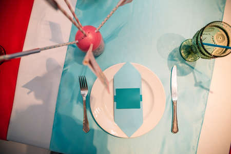 a set table at a children's party with an envelope for your design.