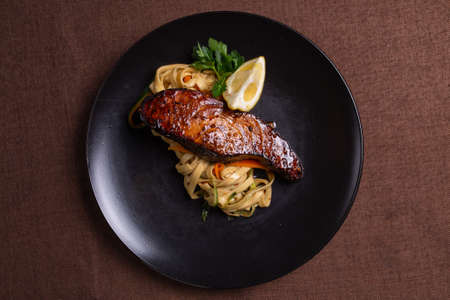 pasta with salmon with soy sauce close-up on a plate.の写真素材