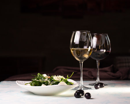 salad with rye and cheese and white wine, olives on the background.の写真素材