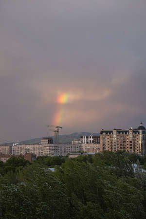 rainbow after rain on a summer day view from the window.のeditorial素材