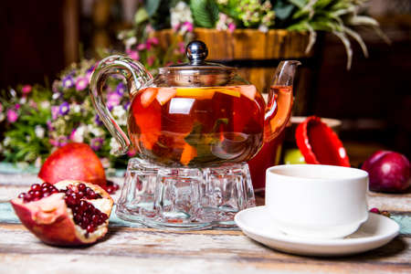 red fruit tea with pomegranate and white cup on the table.の写真素材