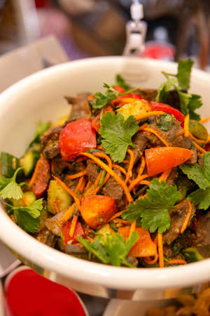 spicy meat with carrots, vegetables and herbs close-upの写真素材