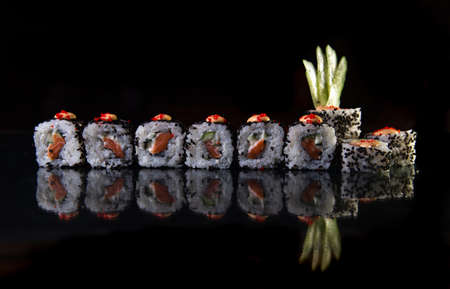 sushi with fish and chia seeds on a black background.の写真素材