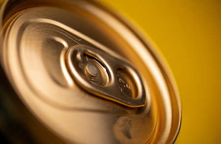 key on a metal beer can on a yellow background.の写真素材