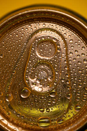 key on a cold metal beer can with condensate.