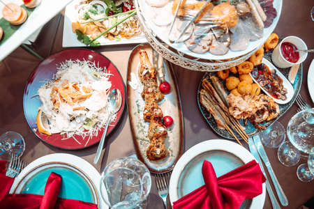 Different dishes on the table in the restaurant at the festival. View from above