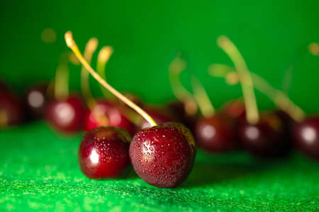 ripe red cherry on a green backgroundの写真素材