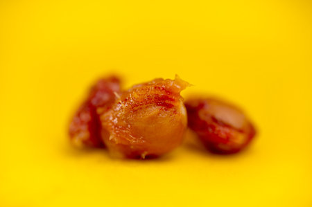 cherry pits, fruit pits on a yellow background.の写真素材