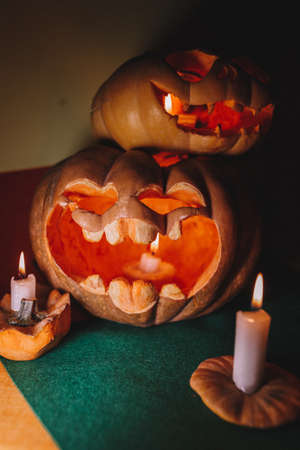 carved pumpkin faces for halloween with candles.の写真素材