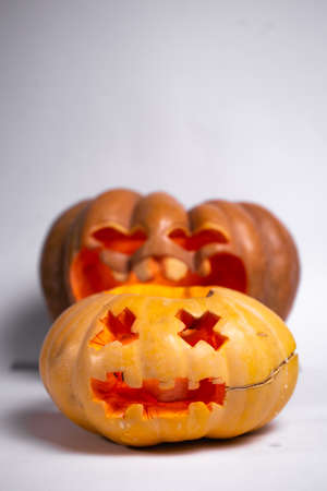 two pumpkins for halloween on a white backgroundの写真素材