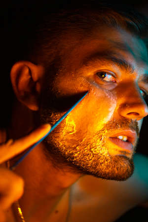 portrait of a man shaving with a knife
