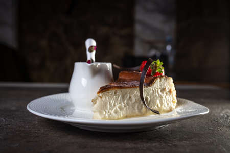 cheesecake with cheese filling with strawberries on a white plate.の写真素材