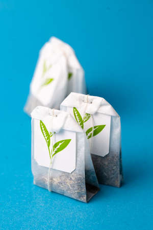 herbal tea bags on a blue background.の写真素材