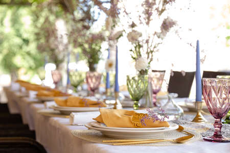 decorative table setting with beautiful dishes and flowers.