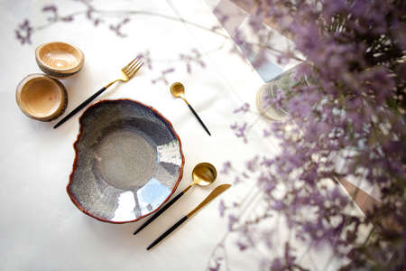 decorative table setting with beautiful dishes and flowers.の写真素材