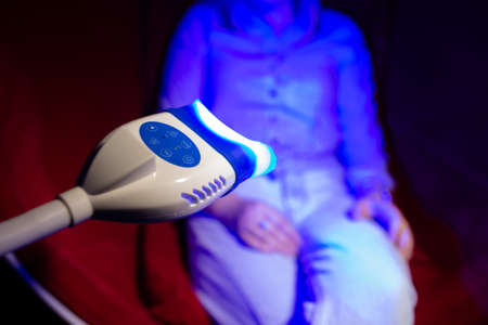 The UV lamp shines on a human background.の写真素材