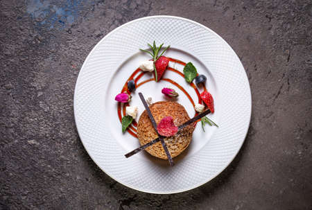 shortbread cookies on a white plate with berries.