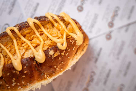 a fast food hot dog on the table in a cafe.の写真素材