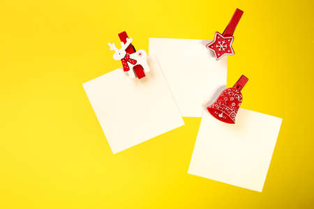 three white notes with a red clothespin.