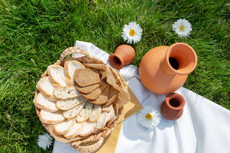 An earthenware jug and bread in a basket. top view.の写真素材
