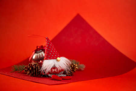 christmas toys and a red dwarf on a red background.の写真素材