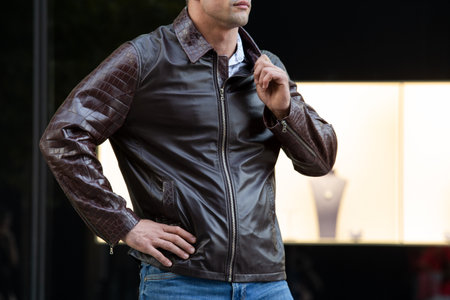 a man without a face in a stylish leather jacket on the street.の写真素材