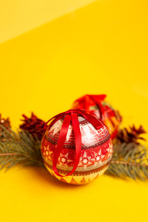red christmas tree toys on a yellow background.の写真素材