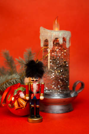 nutcracker and Christmas toys on a red background.