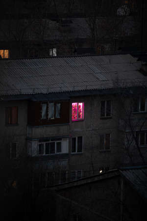 the window glows red in the house.の写真素材
