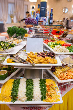 fish slicing and various dishes on the buffet in the restaurant.の写真素材