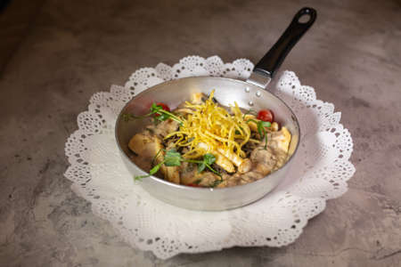 pancakes with mushrooms and potatoes pie in a frying panの写真素材