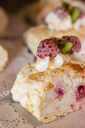 dessert meringue roll with meringue cream close-up.