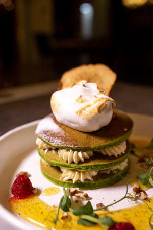 stack of green pancakes with cream close-up.の写真素材