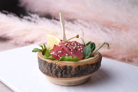 bruschetta with wooden dishes with sliced tuna.の写真素材