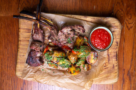 meat on the bone with potatoes and sauce.の写真素材