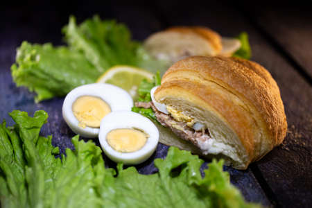 fresh tuna croissant lettuce leaf and egg.