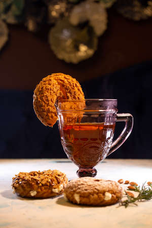 donut with nuts and a glass of tea.の写真素材