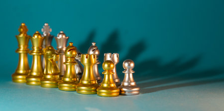 gold and silver chess pieces on a blue background.