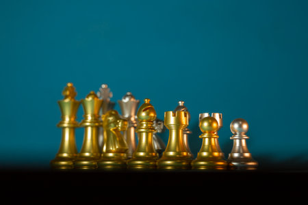 gold and silver chess pieces on a blue background.